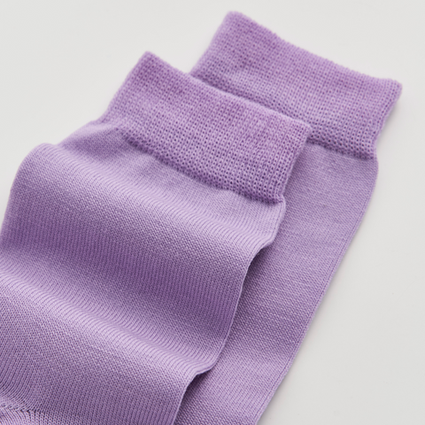 Pair of purple socks on a light gray background