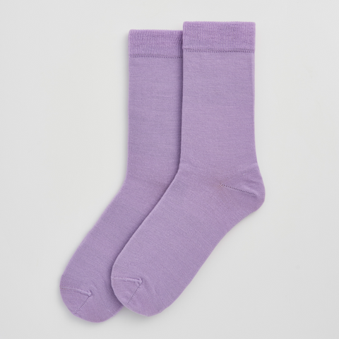 Pair of purple socks on a light gray background