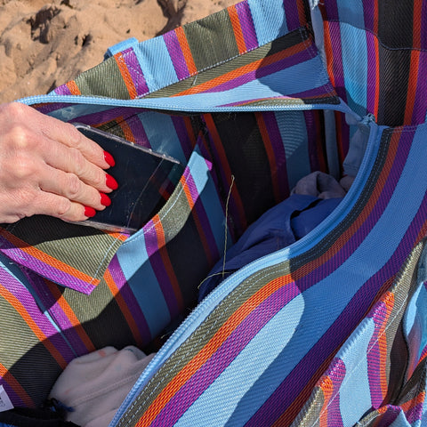 Multicolored striped bag on a sandy surface
