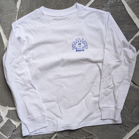 White long-sleeve shirt with a blue logo on a stone floor