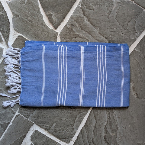 Blue striped towel on a stone surface