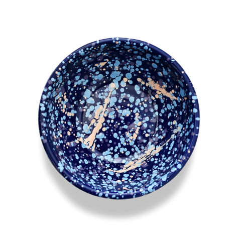Blue speckled enamel bowl with pink and sky blue accents on a white background