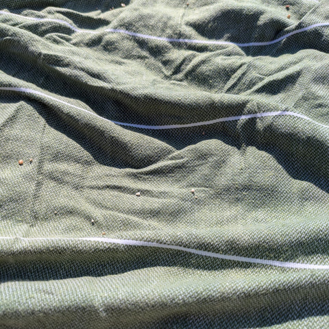 Close-up of green hamman towel with white stripes