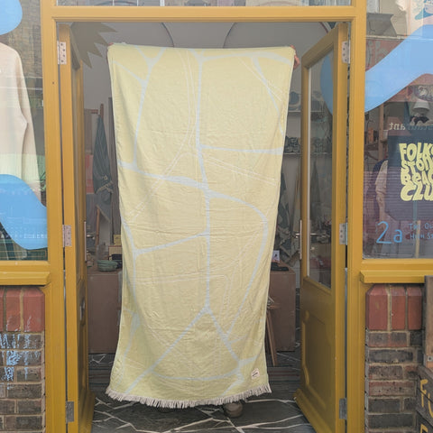 Yellow towel held up in a shop doorway