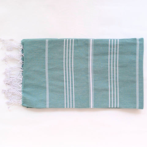 Teal towel with white stripes and fringes on a white background