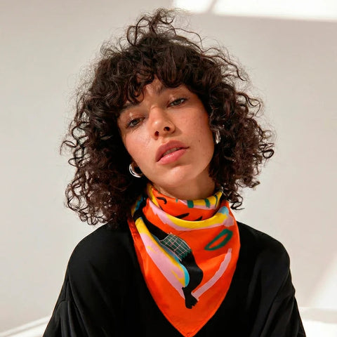 Woman wearing a colorful scarf with a black t-shirt